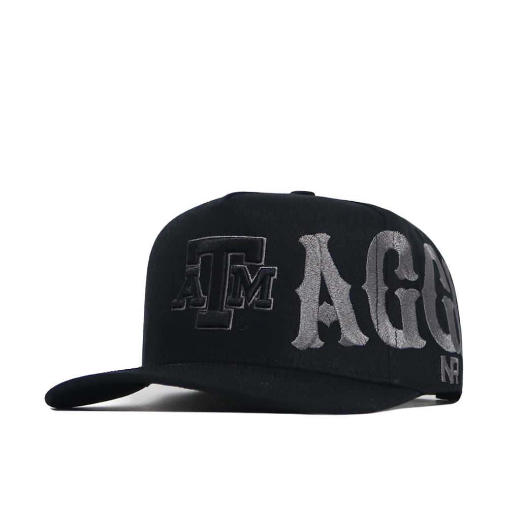 The Texas A&M Night Mode Hat by No Rivals is a black snapback with a high crown and structured fit, featuring bold gray ATM AGG embroidery on the front and side for Aggies fans.