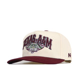 The No Rivals Texas A&M Stadium Hat is a cream and maroon snapback featuring "Texas A&M Aggies" above a stadium graphic, a maroon brim, structured fit, high quality cotton, and a small NR logo on the side.