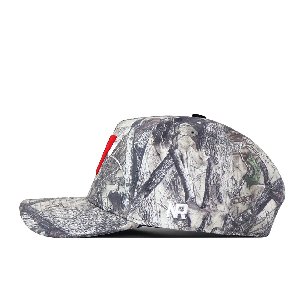 The Wisconsin Badgers Outland Hat by No Rivals features a camouflage pattern with a bold red embroidered “N” on the front and a small white NR logo on the side. It comes with a classic snap back adjustment for the perfect gameday fit and is shown in profile view against a white background.