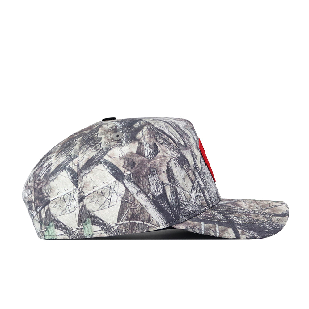 A side view of the No Rivals Wisconsin Badgers Outland Hat showcases its camouflage pattern and a red embroidered Wisconsin Badgers logo on the front. The classic snapback adjustment ensures a perfect gameday fit, and the hat is set against a plain white background.