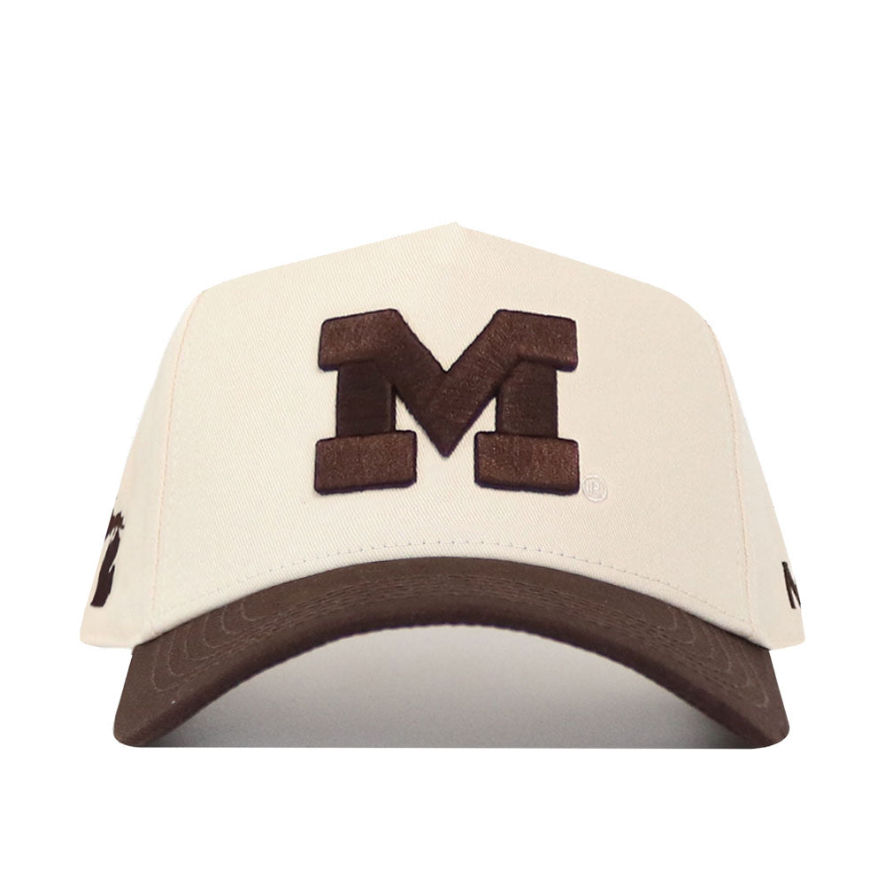 The Michigan Wolverines Espresso Hat by No Rivals features a cream-colored design with a bold brown embroidered letter M on the front, a matching brown brim, and a classic snap back closure.