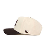 A cream-colored Michigan Wolverines Espresso Hat by No Rivals, featuring a dark brown brim and an officially licensed NR embroidered logo in brown on the side, with an adjustable snap back for a comfortable fit.