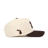 Introducing the Michigan Wolverines Espresso Hat by No Rivals—a cream-colored baseball cap accented with a brown brim and an embroidered outline of Michigan state in brown on the side. This stylish snapback is officially licensed to guarantee authenticity and quality.