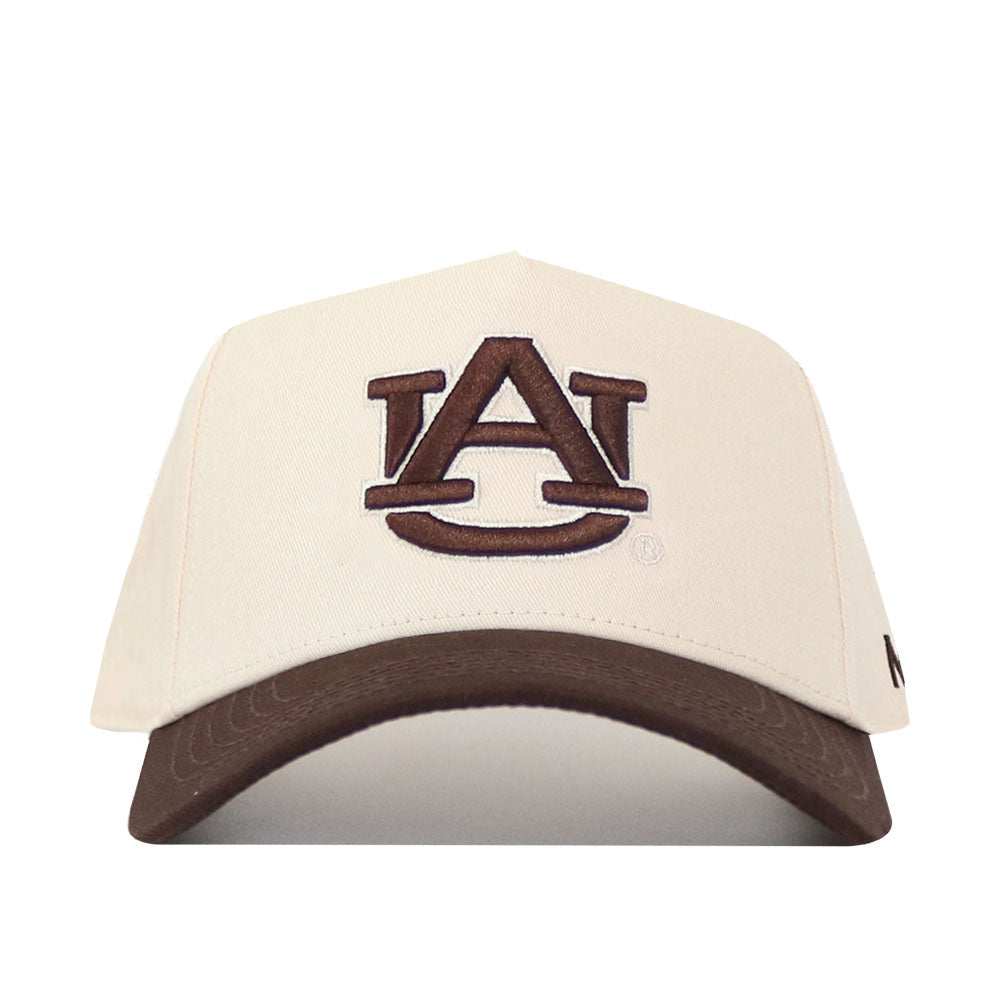 The Auburn Espresso Hat by No Rivals features a beige crown and a brown bill, highlighted by a large embroidered AU logo on the front. Its classic snap back design makes it the perfect gameday fit for any Auburn University fan.