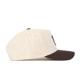 Side view of the No Rivals Auburn Espresso Hat, featuring a cream-colored crown and a dark brown brim with an embroidered logo on the front. The classic snapback design offers an adjustable fit, showcased against a plain white background.