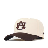 The Auburn Espresso Hat by No Rivals is a beige and brown baseball cap featuring the embroidered Auburn University AU logo on the front—perfect for your gameday look. It has a brown brim, the New Era logo stitched on the side, and an adjustable snap back for a comfortable fit.