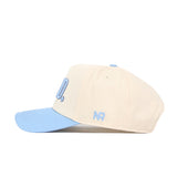 The No Rivals GTHD Hat is a beige snapback with a light blue brim and button, featuring officially licensed blue embroidered NR letters on the side.