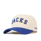 Show your South Dakota State Jackrabbits pride with the Right Side Up Jacks Hat - Classic by No Rivals. This beige snapback features “JACKS” embroidered in bold blue and yellow lettering on the front, complemented by a curved blue brim. An adjustable closure offers a customizable fit, while the partially visible “NO RIN”—a signature of No Rivals—adds unique style to this must-have accessory.