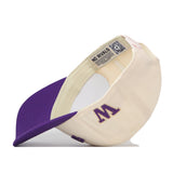 The No Rivals Washington Huskies Upside Down Huskies Hat - Classic is a cream and purple snapback baseball cap featuring a purple W logo on the side. Shown flipped to reveal the interior, the cap displays an inverted logo, a QR code, “NO RIVALS” text, and visible inner stitching.