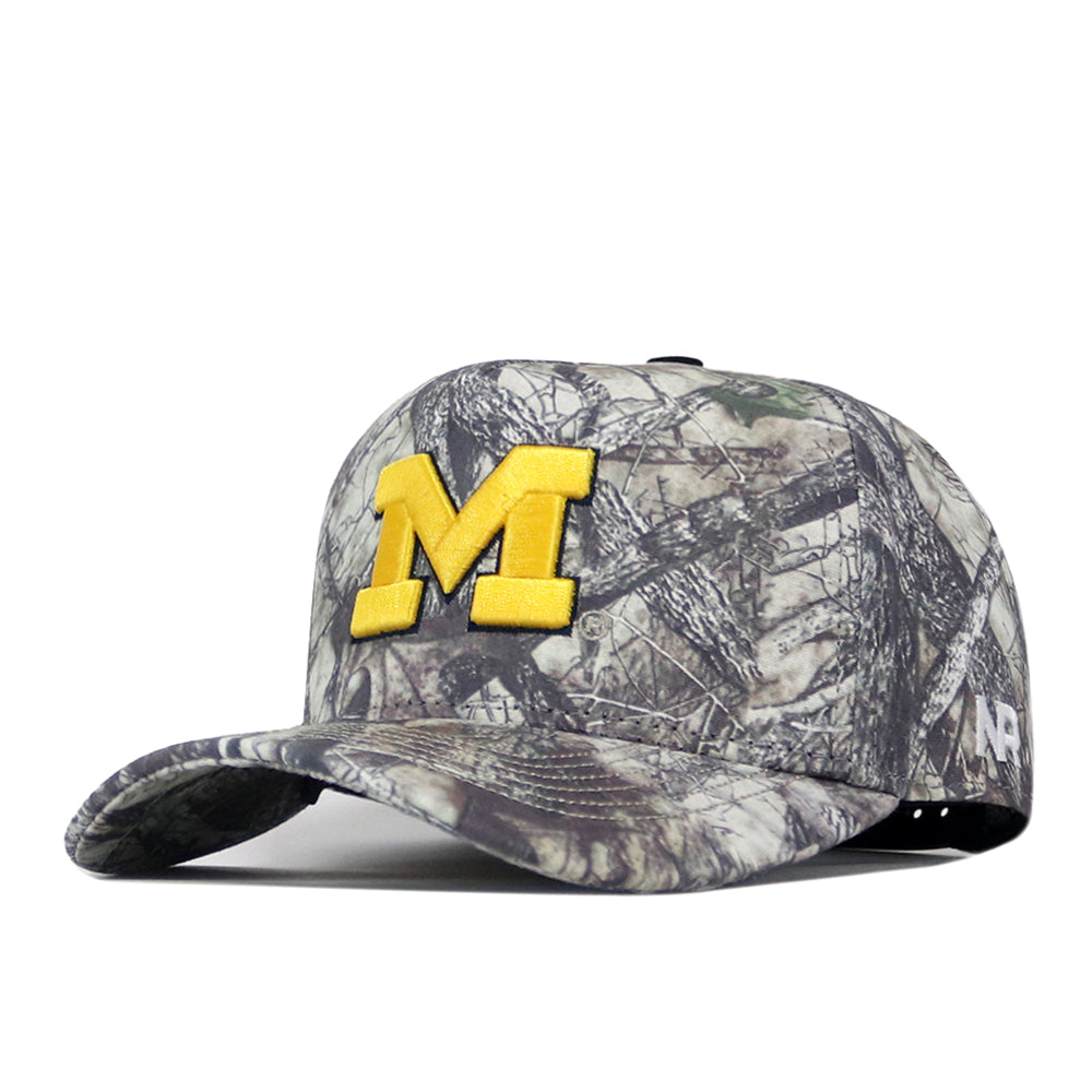 The No Rivals Michigan Wolverines Outland Hat is a camouflage baseball cap featuring a large, officially licensed yellow M embroidered on the front and a small ’47 logo on the side.
