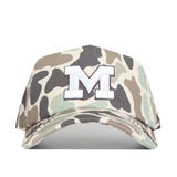 The No Rivals Michigan Wolverines Huntsman Hat is a camouflage snapback baseball cap featuring a bold white embroidered “M” outlined in black on the front. With its mix of green, brown, and tan shades, this hat is the perfect finishing touch for your gameday outfit.