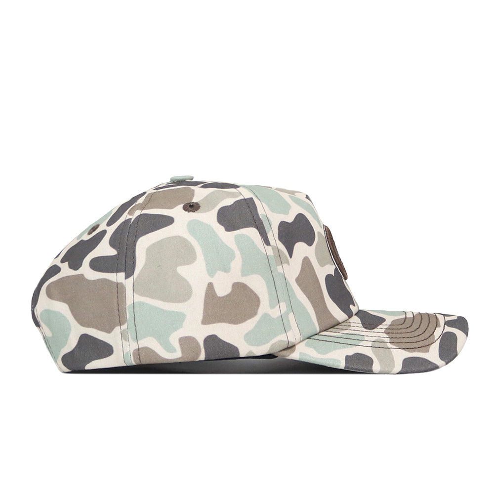 Side view of the Georgia Bulldogs Huntsman Hat by No Rivals, showcasing a camouflage pattern in shades of green, brown, and beige. Crafted from high-quality cotton, this structured fit cap features a flat brim and a round crown with a button on top.