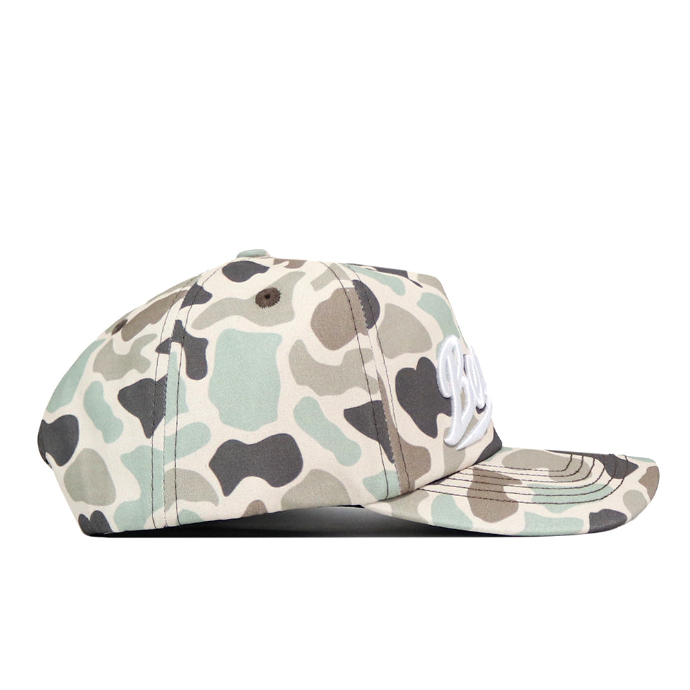 A side view of the No Rivals Sam Houston State Huntsman Hat reveals its camouflage pattern, flat brim, and front white embroidered logo. This high-quality cotton cap features a convenient snap back closure.