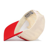 A Nebraska Cornhuskers Stride Hat by No Rivals is turned inside out, revealing the underside of the brim and a label with the No Rivals logo next to a QR code. This officially licensed snapback cap rests on a white surface.