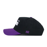 The No Rivals LSU Tailgate Hat is a black snapback baseball cap with a purple brim, shown in side view. "NR" is embroidered in purple above the ear, and part of the white front design is visible. Made from high-quality cotton.