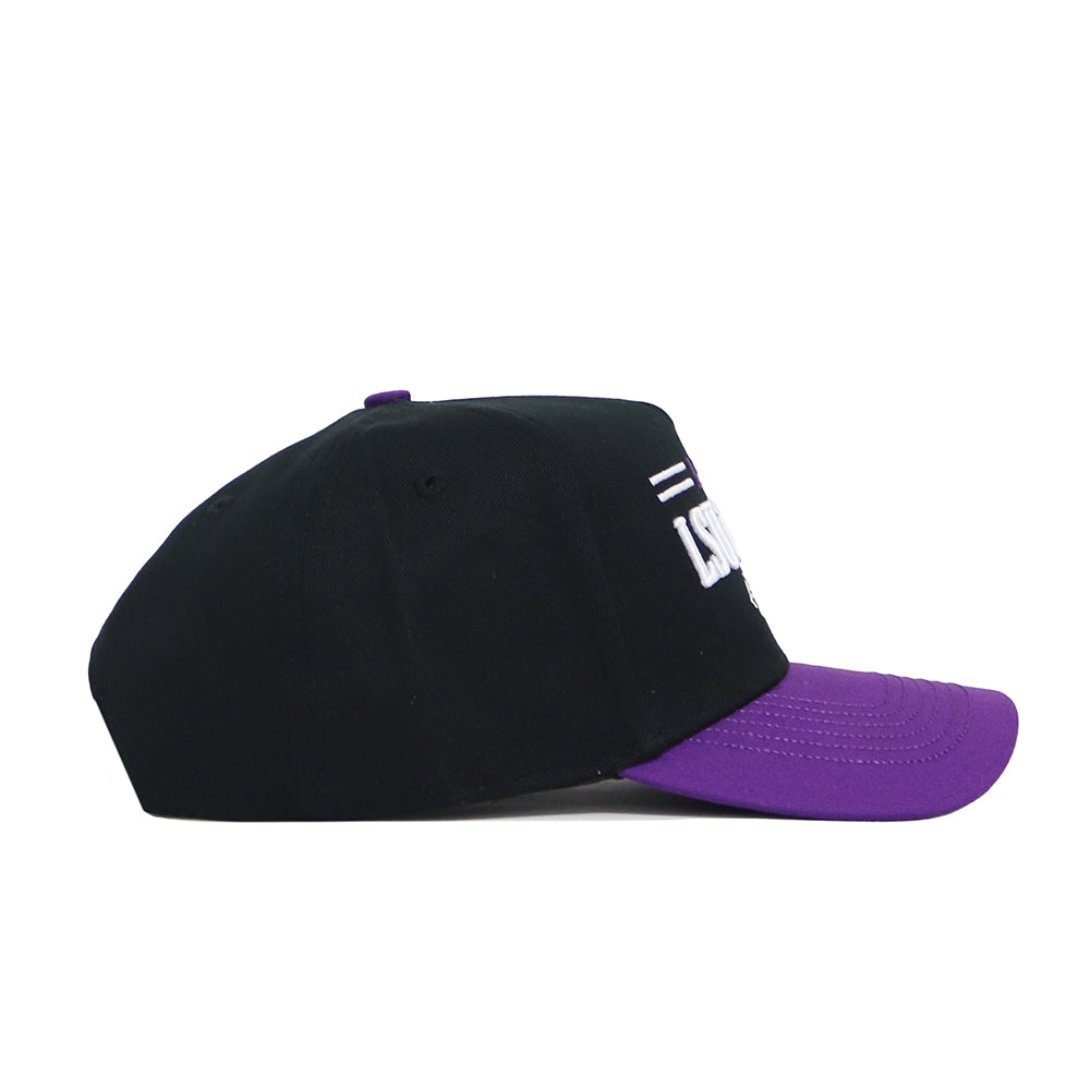 The LSU Tailgate Hat by No Rivals is a black snapback with a purple brim, shown from the side. This structured cotton cap features partially visible white embroidered text above the brim on the front.