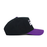 The LSU Tailgate Hat by No Rivals is a black snapback with a purple brim, shown from the side. This structured cotton cap features partially visible white embroidered text above the brim on the front.