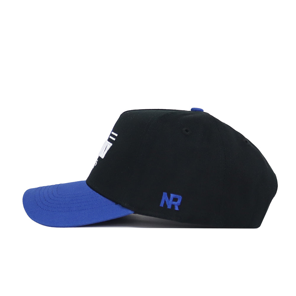 The No Rivals Kentucky Tailgate Hat is a black snapback with a blue brim and blue NR initials on the side, made from high-quality cotton and displayed from a side view against a white background.