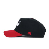 The Arkansas Tailgate Hat by No Rivals is a structured black cotton baseball cap with a red brim and a small red NR logo embroidered on the side, shown in side profile.