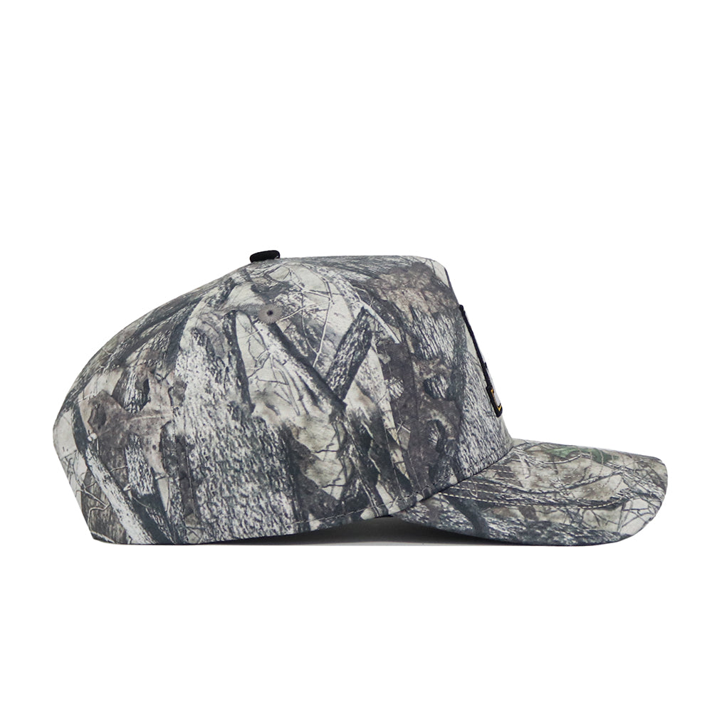 The No Rivals App State Outland Hat is shown in a side view, featuring a camouflage pattern with gray, brown, and green shades. Made from high-quality cotton, it includes an adjustable snap back for a comfortable fit.