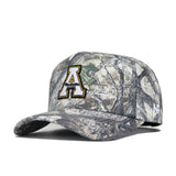 The No Rivals App State Outland Hat is an officially licensed cotton baseball cap with a classic woodland camo pattern, a curved brim, and a striking letter A outlined in black, white, and gold on the front.