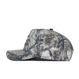 Side view of the Michigan State Outland Hat by No Rivals, a structured fit camouflage snapback in gray, black, and white cotton with a flat brim and visible stitching, shown on a white background.