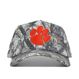 The Clemson Outland Hat by No Rivals is a high-quality cotton snapback camo baseball cap featuring an embroidered orange paw print logo on the front. Officially licensed.
