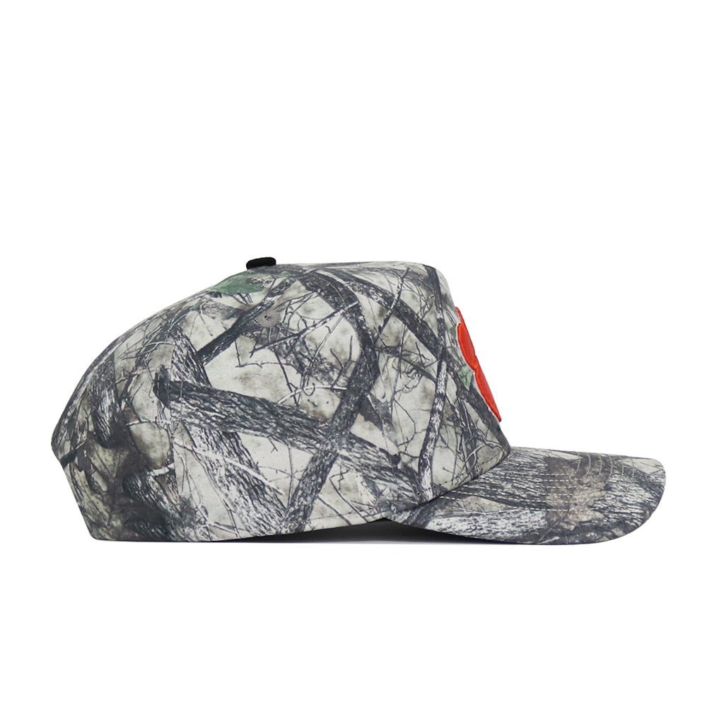 A side view of the No Rivals Clemson Outland Hat, a snapback with a flat brim. It features high quality camouflage cotton in gray, black, and green with a tree-branch print and a partially visible red front design.