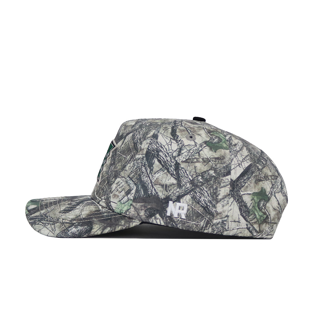 A side view of the No Rivals Hawaii Outland Hat shows a camouflage-patterned, high-quality cotton snapback with a curved brim, structured crown, and white "ND" embroidery on the side for a comfortable fit.
