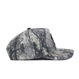A side view of the No Rivals Florida State Outland Hat, a structured snapback with gray and black tree bark camo, made from high-quality cotton, shown against a plain white background.
