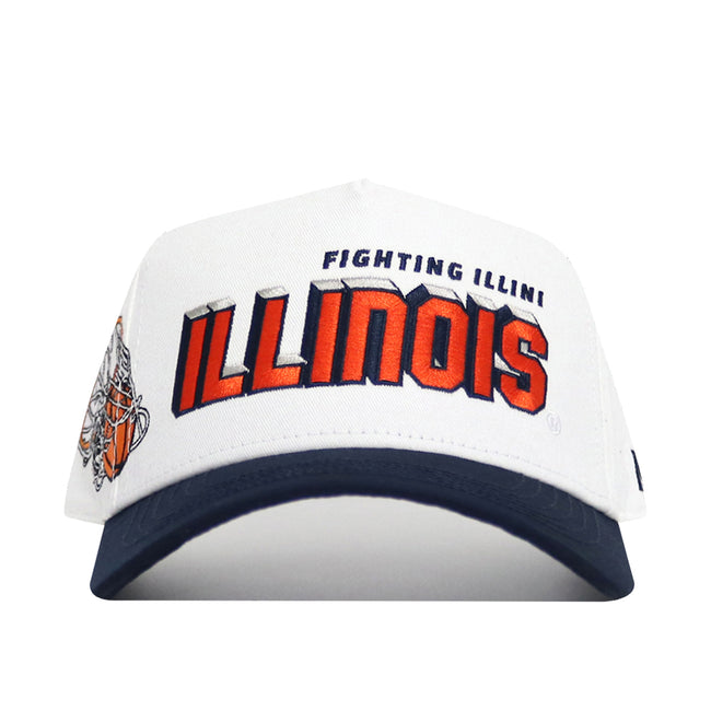 The Illinois Courtside Hat is a structured white baseball cap with a navy brim, featuring “Fighting Illini ILLINOIS” in orange and blue on the front, a graphic logo on the left side, and made from high-quality cotton.