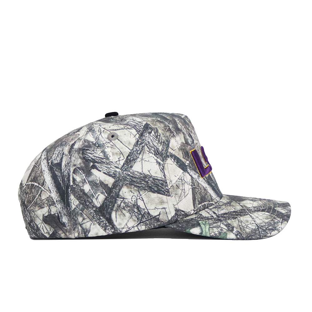The No Rivals LSU Outland Hat is a flat-brim snapback with a gray and black camo print and a purple-and-yellow rectangular side patch, made from high-quality cotton and pictured in profile on a white background.