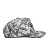 The No Rivals LSU Outland Hat is a flat-brim snapback with a gray and black camo print and a purple-and-yellow rectangular side patch, made from high-quality cotton and pictured in profile on a white background.