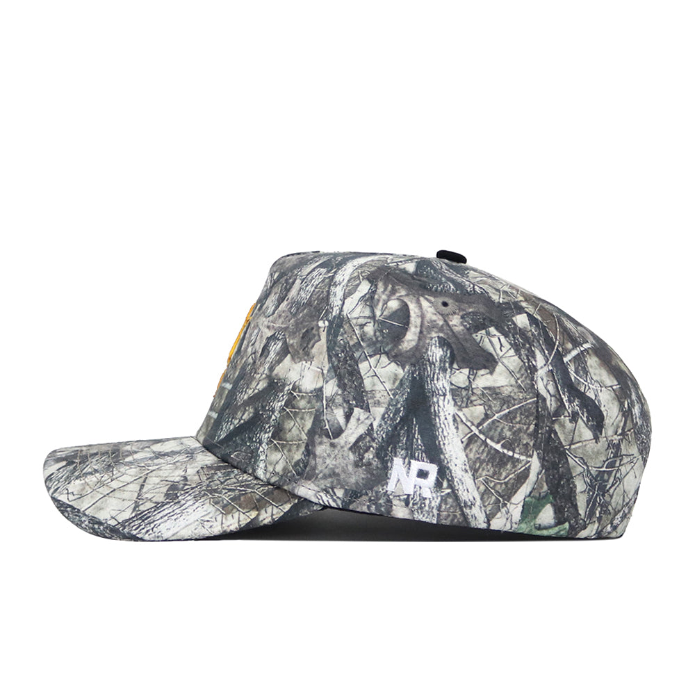 The No Rivals Arizona State Outland Hat is a camouflage-patterned, flat-brim snapback cap shown in side profile. Made from high-quality cotton with a structured fit, it features white embroidered NR letters near the back.