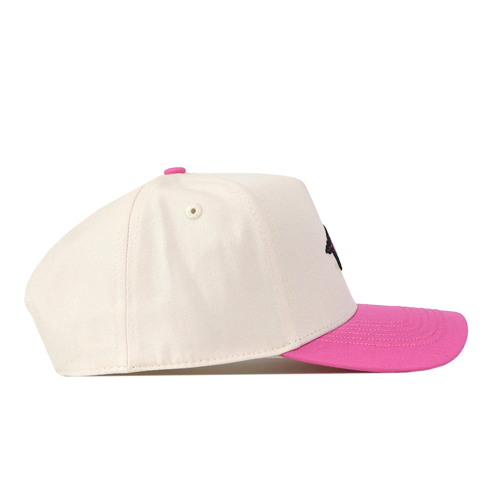The No Rivals Arkansas Pink Out Hat is a cream-colored baseball cap with a bright pink brim, displayed from a side view against a white background, and features a snap back closure for an adjustable fit.