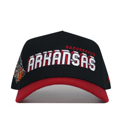 The Arkansas Courtside Hat is a black and red snapback featuring "Arkansas" and "Razorbacks" embroidered on the front, a basketball net graphic on the side, and a structured fit for long-lasting style.