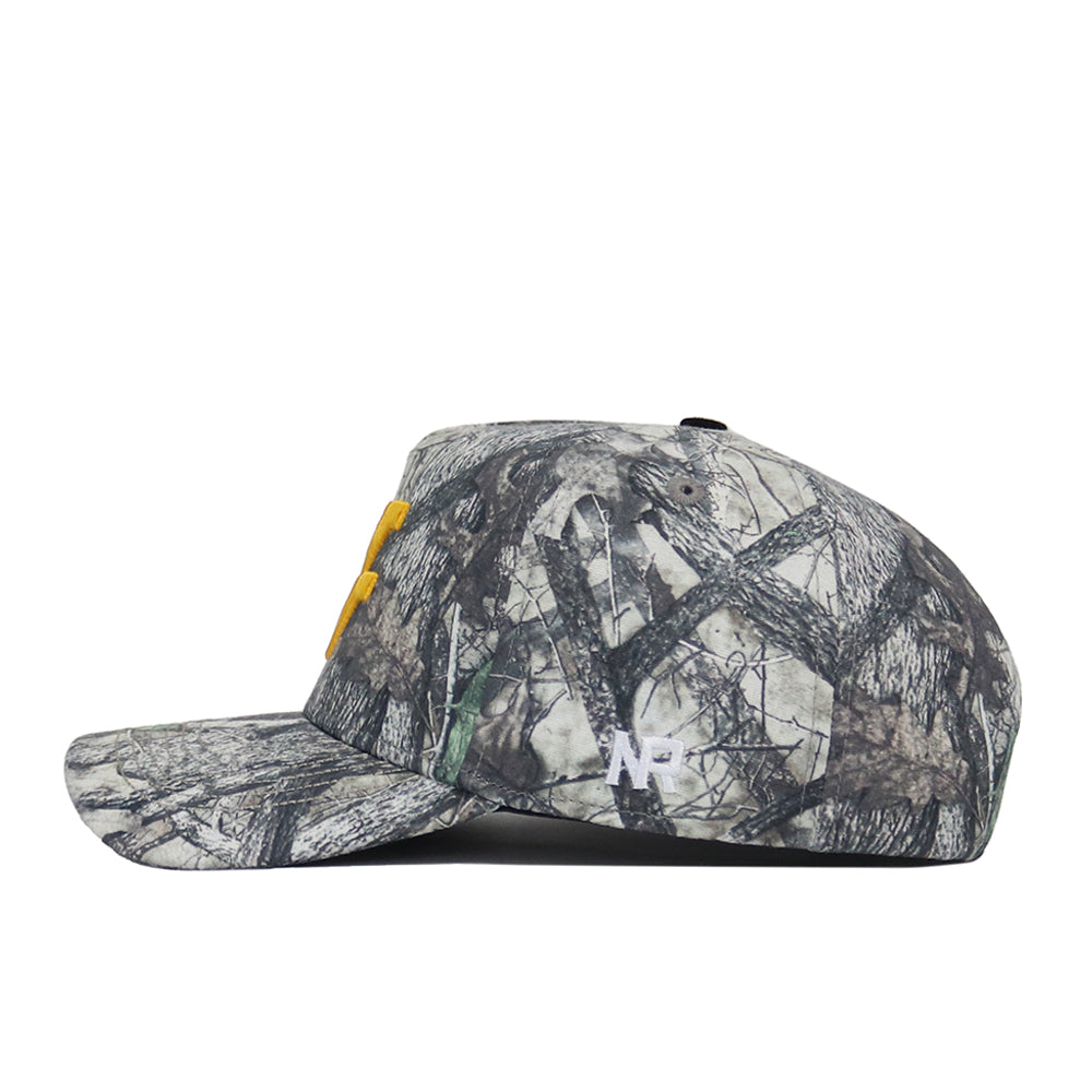 The West Virginia Outland Hat by No Rivals is a camouflage-pattern snapback with yellow embroidered front letters and a small white NF logo on the side, made from high-quality cotton for a structured fit. Shown in side profile against a white background.