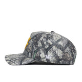 The West Virginia Outland Hat by No Rivals is a camouflage-pattern snapback with yellow embroidered front letters and a small white NF logo on the side, made from high-quality cotton for a structured fit. Shown in side profile against a white background.