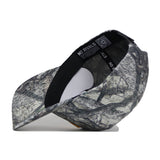 The West Virginia Outland Hat by No Rivals is a camouflage snapback, shown on its side to display black inner bands with “NO RIVALS” in white. Made from high-quality cotton, it features a structured fit against a plain white background.