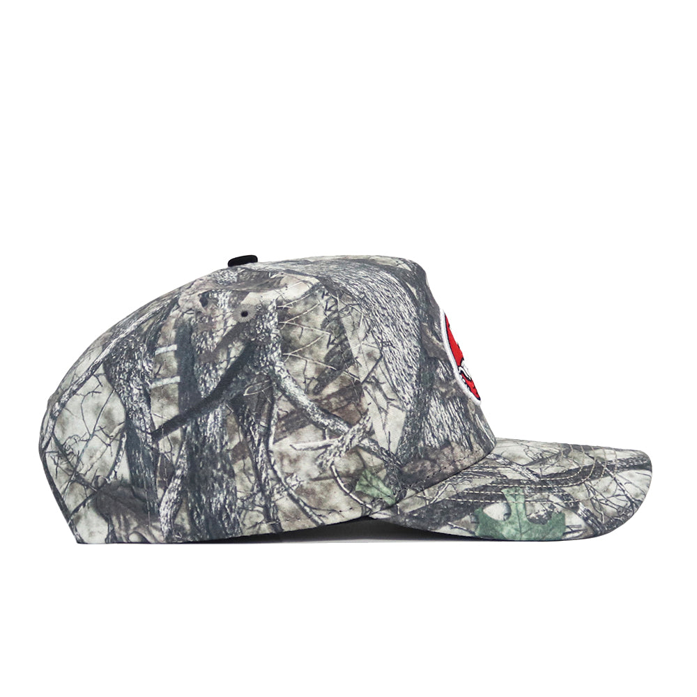 Side view of the No Rivals Western Kentucky Outland Hat, a structured fit cap in green, brown, and gray camo cotton with a partially visible red and white embroidered patch on the front.