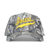 The No Rivals Iowa Outland Hat is a camo-pattern baseball cap crafted from premium cotton, with "Iowa" embroidered in yellow cursive on the front.