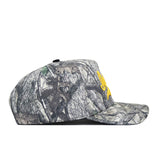 The Iowa Outland Hat by No Rivals is a camouflage cap with a yellow logo, made from high-quality cotton and featuring an adjustable snap back.