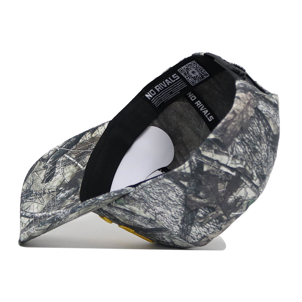 The Iowa Outland Hat by No Rivals is a high-quality cotton camo baseball cap, shown upside down to display the inner black band labeled NO RIVALS. It features a curved brim, QR code inside, and an adjustable snapback closure.