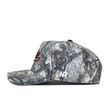 A side view of the Mississippi State Outland Hat by No Rivals, a woodland camouflage snapback with a red embroidered logo on the front, white NR initials on the side, high-quality cotton, and a curved brim.