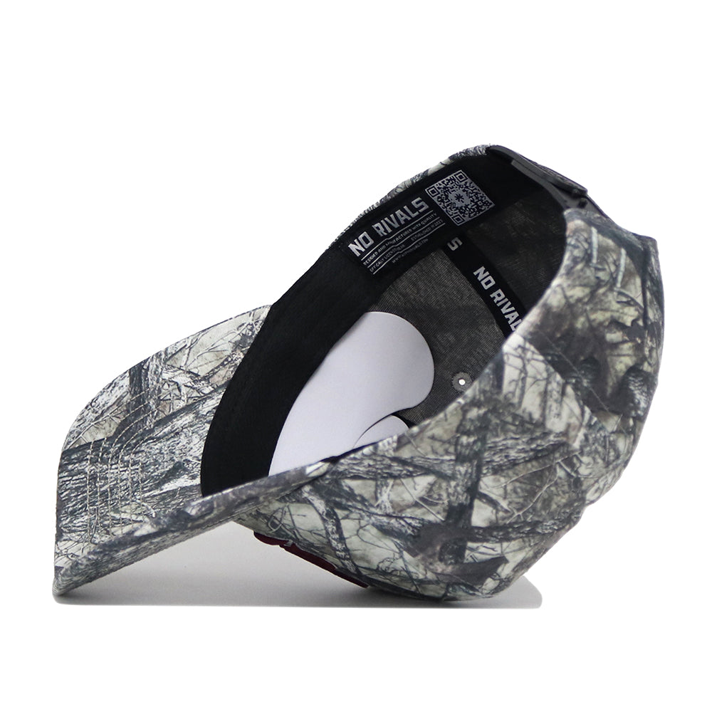 The Mississippi State Outland Hat by No Rivals is a camo-patterned baseball cap made from high quality cotton, shown from below to highlight its interior lining, black NO RIVALS seam tape, and a curved brim.