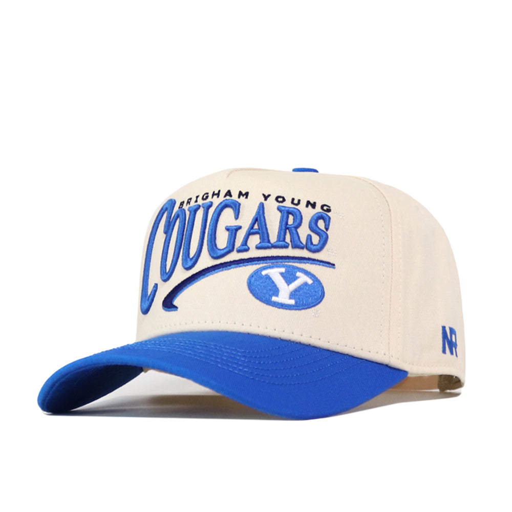 The BYU Cougars Stride Hat by No Rivals features a beige and blue snapback design with bold blue embroidered “Brigham Young Cougars” lettering and the BYU logo on the front. Complete with a blue brim and NR initials on the side, it’s the perfect addition to your gameday fit.