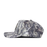 The Baylor Outland Hat by No Rivals is a camouflage-patterned baseball cap, crafted from high-quality cotton and shown from the side. It features a flat brim and an embroidered white logo near the back.