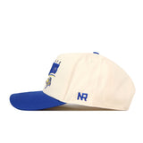 The South Dakota State Jackrabbits Stride Hat by No Rivals is a white snapback with a royal blue brim, featuring blue embroidered logos and text on the side and front. The letters “NR” are stitched on the side, while the front displays a yellow and blue mascot—making it the perfect addition to your gameday outfit.