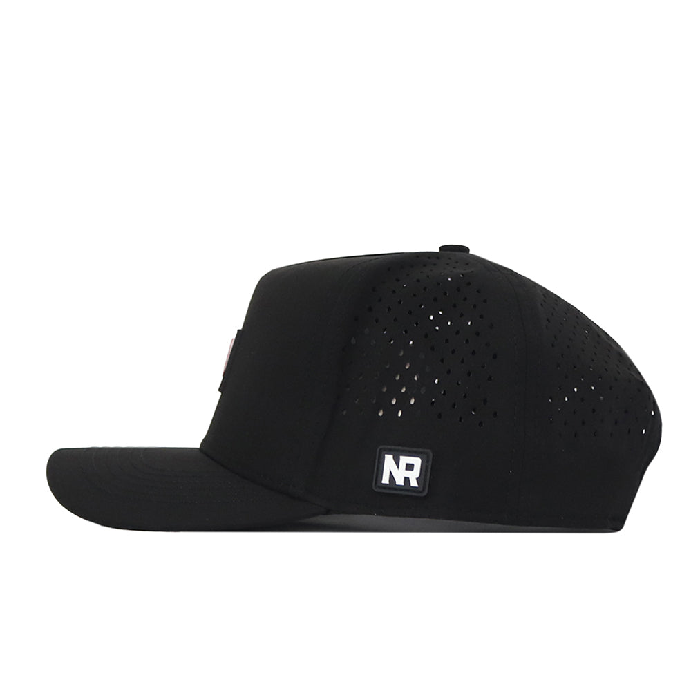 Introducing the Wisconsin Badgers Trainer Hat by No Rivals—a black snapback cap featuring a structured fit, flat brim, and side ventilation holes. Made from durable cotton material, it showcases a small rectangular NR logo patch on the side. The hat is presented in a side profile against a white background.