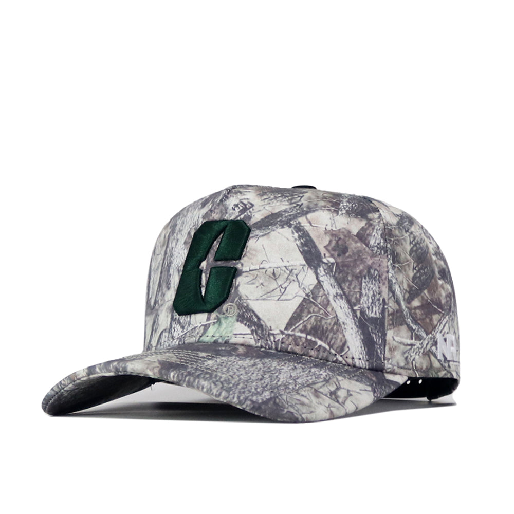 The Charlotte Outland Hat by No Rivals is a camouflage baseball cap showcasing a large, dark green embroidered letter C on the front, angled against a white background. Its convenient Snap Back Adjustment provides a comfortable and secure Gameday Fit every time.